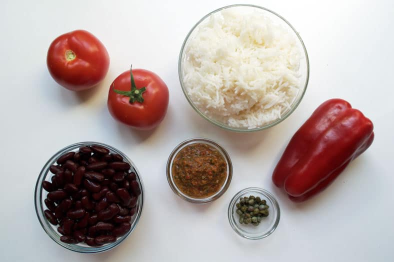 These are the basic ingredients to make Puerto Rican Mamposteao - rice, tomatoes, beans, sofrito, red pepper