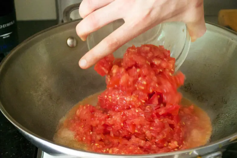 The beginning stage of creating Singapore's chili crab - here we are starting to saute freshly peeled and diced tomatoes