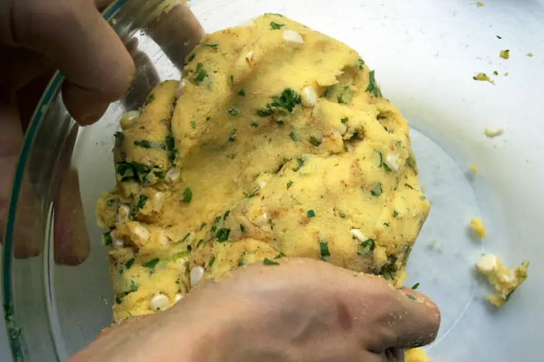 To make Venezuelan arepes, you want to use your hands to mix and well distribute the different ingredients in the dough