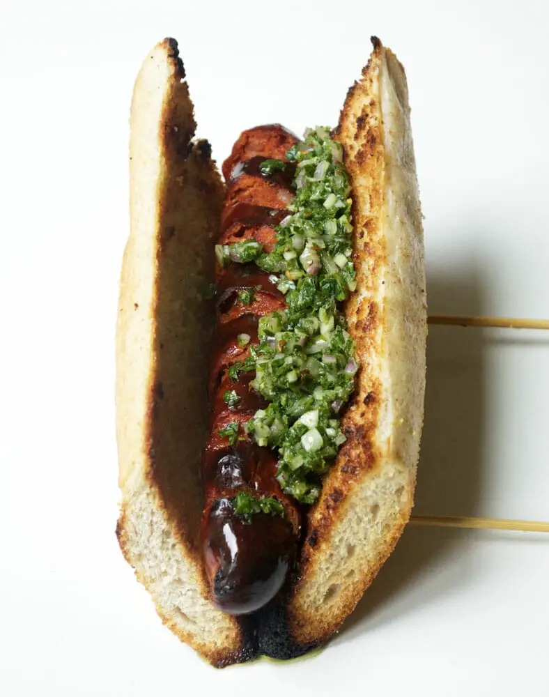 A staple of Argentinian cuisine, often sold as street food, is the Choripan. It’s essentially a grilled chorizo sausage inside a toasted baguette topped with a heaping dollop of chimichurri.