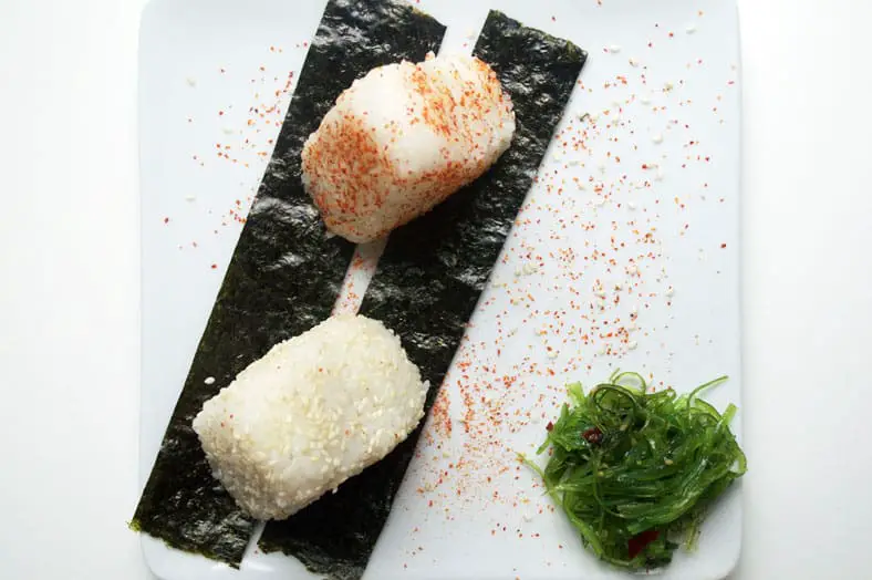Japanese onigiri stuffed with teriyaki salmon and sautéed gobo root, carrots and red chili