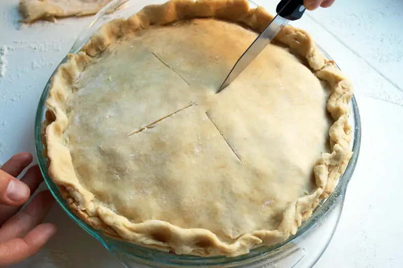 Before baking your pie, do cut in some slits to help let excess steam out. This will make sure that the pie crust doesn't collapse on the meat filling of your tourtière (Canadian Christmas Spiced Meat Pie)