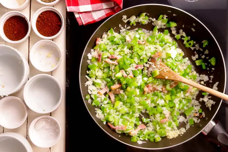 To make oyster cajun stuffing, you'll start by sauteeing you aromatics - onions, garlic, peppers
